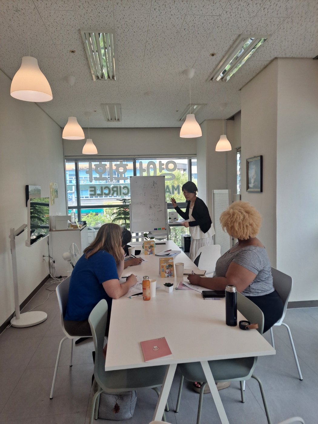 Students engaged in Korean language learning with textbooks